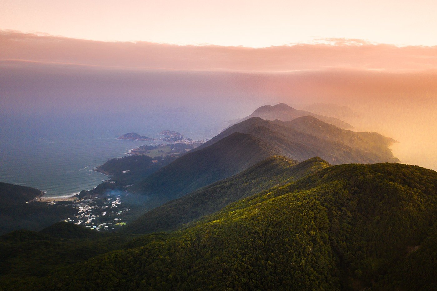 a view of the ocean and mountains from a plane.