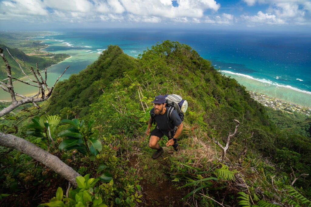a man hiking up the side of a mountain.
