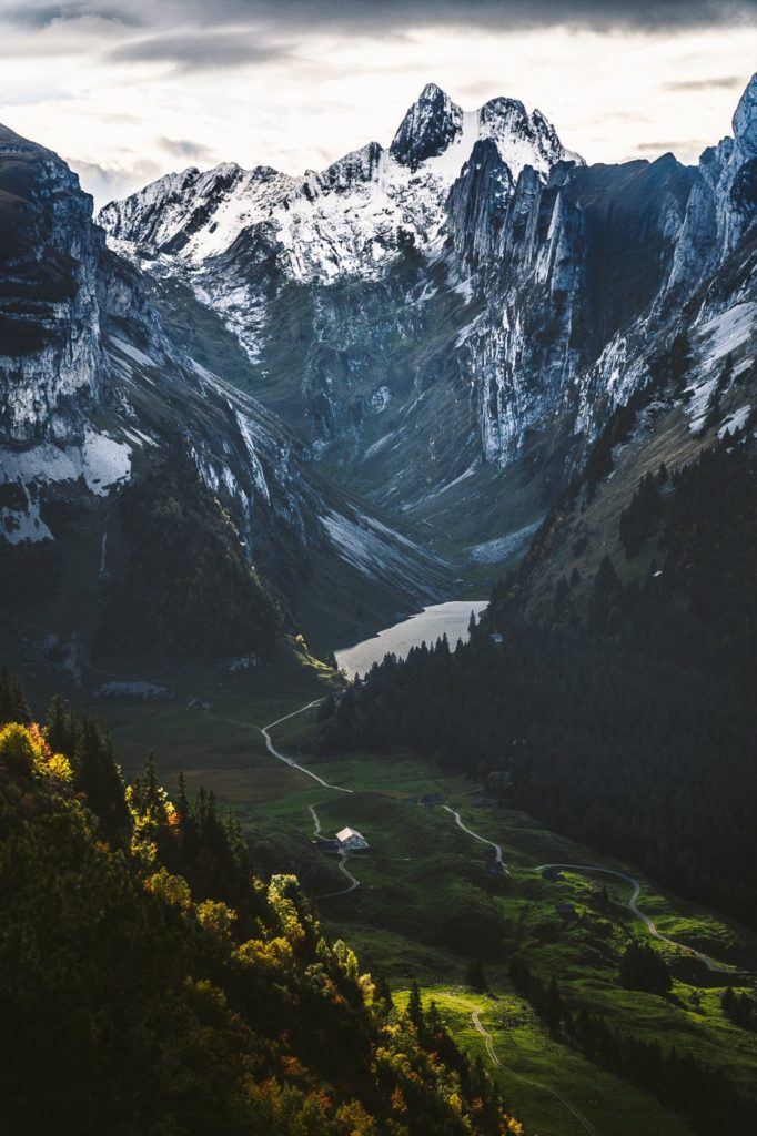 a view of a valley with mountains in the background.