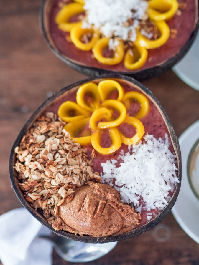 a couple of bowls filled with food on top of a table.